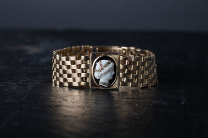 9ct gold vintage bracelet featuring a Mother of Pearl cameo with rose cut emerald and diamond headdress on a wide link band.