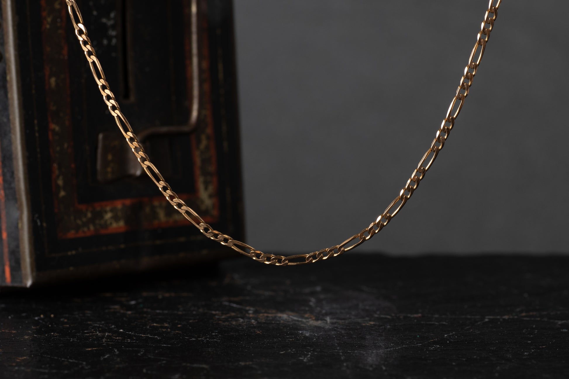 9ct yellow gold Figaro link chain necklace featuring a pattern of three small circular links and one elongated oval link.