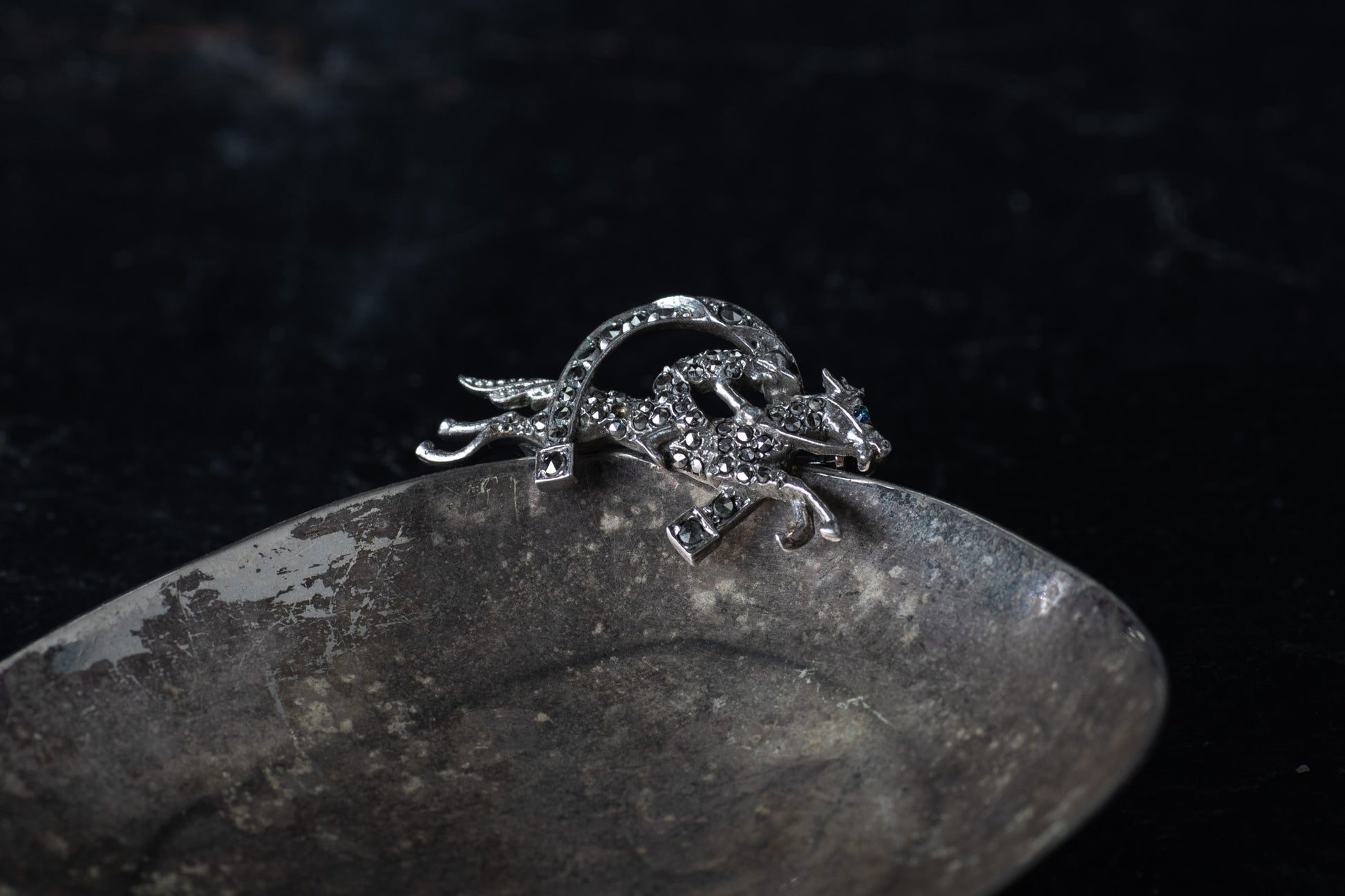 Vintage silver brooch depicting a horse and jockey leaping over a fence, pave set with sparkling marcasite stones.