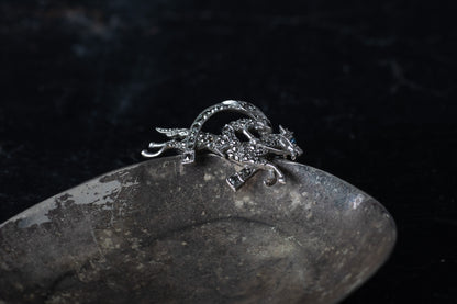 Vintage silver brooch depicting a horse and jockey leaping over a fence, pave set with sparkling marcasite stones.