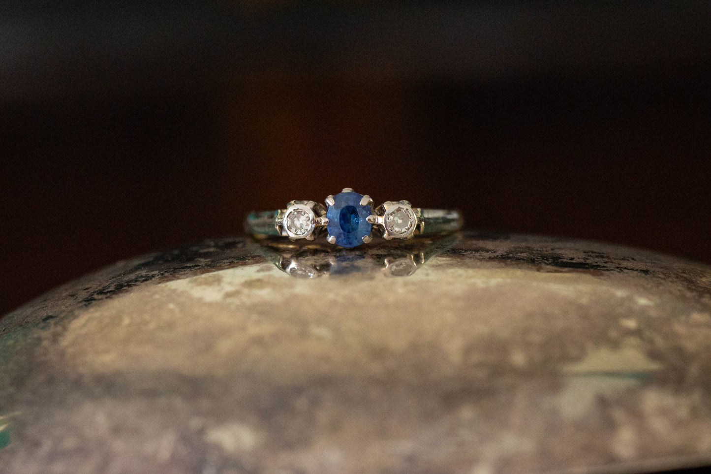 Front view of vintage sapphire and diamond three stone ring claw set in platinum on 18ct gold band.
