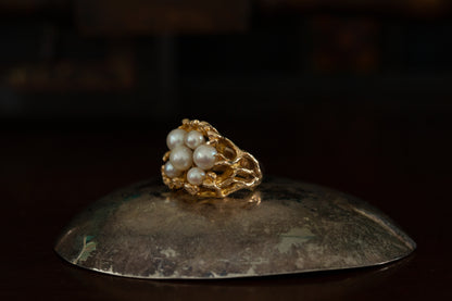 Side view of 10ct yellow gold ring featuring a cluster of white pearls in a textured organic setting on dark background.