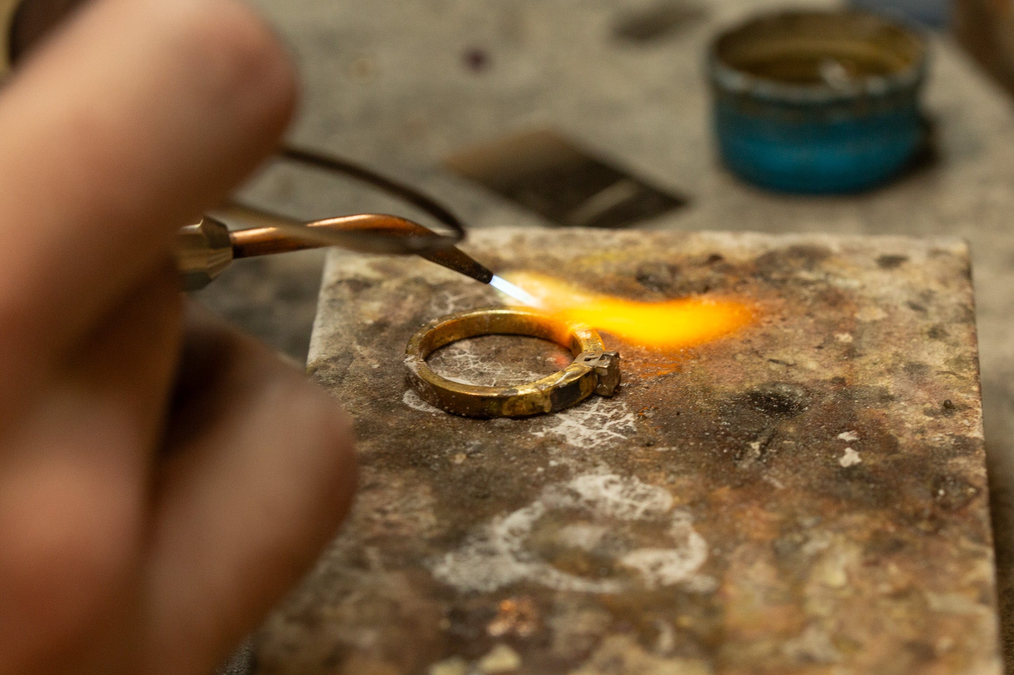 Goldsmith soldering a ring during a restoration